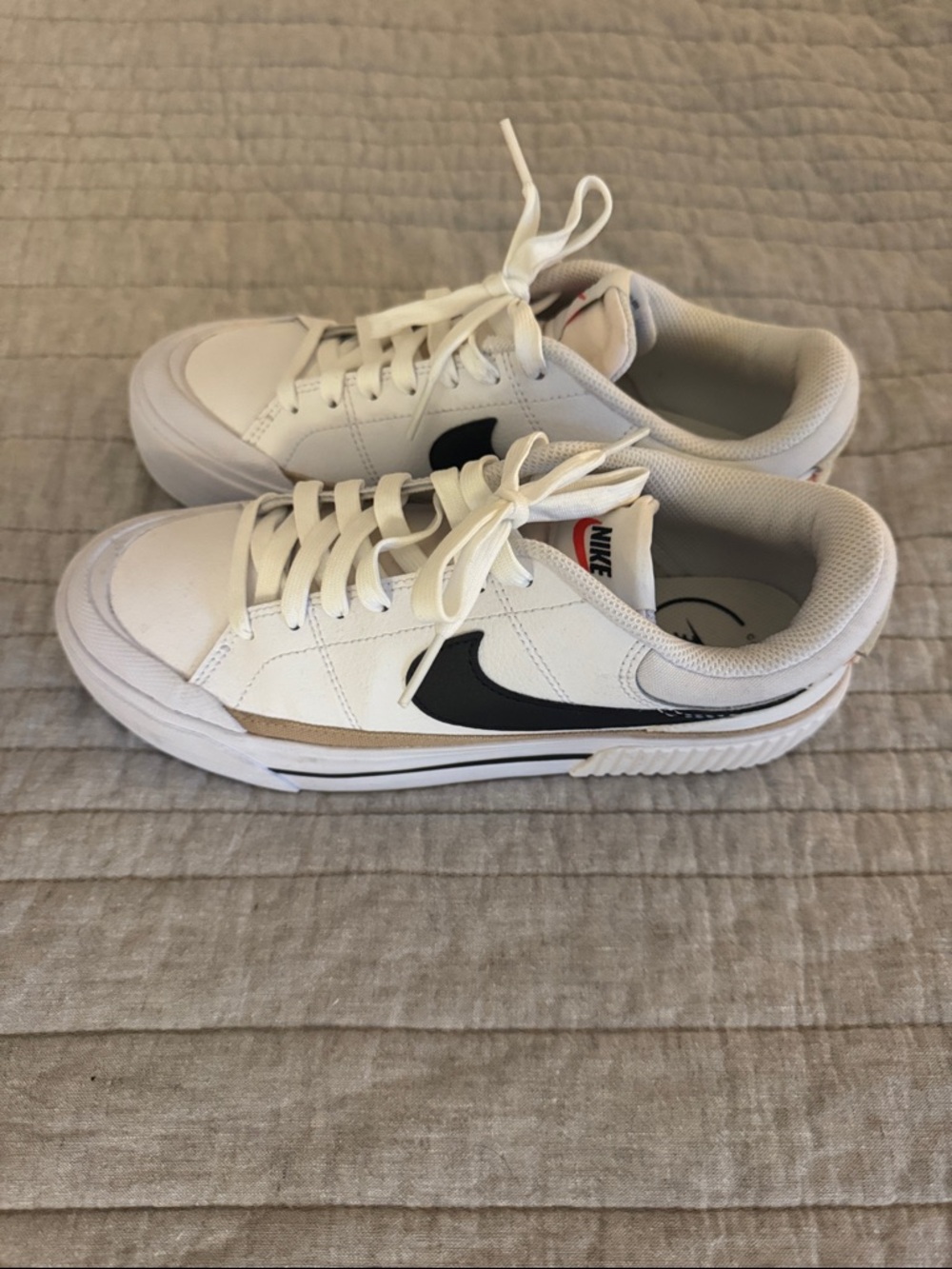 Nike White Low-Top Sneakers with Black Swoosh and Tan Accent